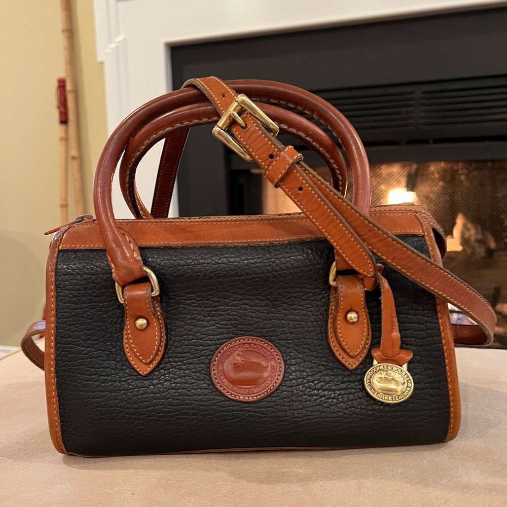 Dooney & Bourke. All Weather Leather. Black and Tan. Mini duffle.